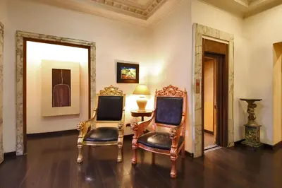a room with two chairs and a table with a lamp at Hotel Nizza in Rome