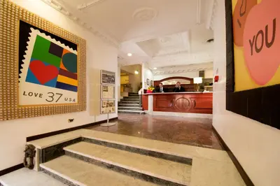 a hallway with a staircase in a building at Hotel Nizza in Rome