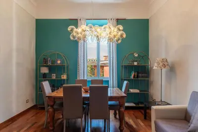 a dining room with a table and chairs and a chandelier at HospitalityRome Domus Colosseo in Rome