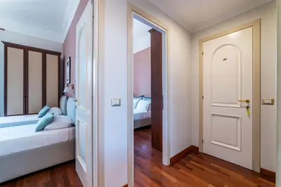 a bedroom with a bed and an open door at HospitalityRome Domus Colosseo in Rome