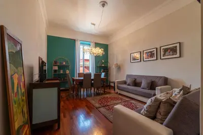 a living room with a couch and a dining room at HospitalityRome Domus Colosseo in Rome