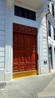 a large wooden door on the side of a building at HospitalityRome Domus Colosseo in Rome