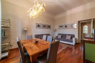 a dining room with a table and a couch at HospitalityRome Domus Colosseo in Rome