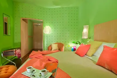 a green bedroom with a bed with two cups on it at Hotel Abitart in Rome
