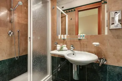 a bathroom with a sink and a shower at Palazzo Cardinal Cesi in Rome