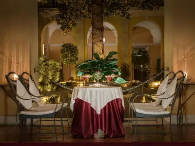 a table with a table cloth on it with chairs at Palazzo Cardinal Cesi in Rome