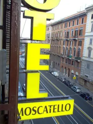 a yellow sign for a mosaccalisto sign on a street at Hotel Moscatello in Rome