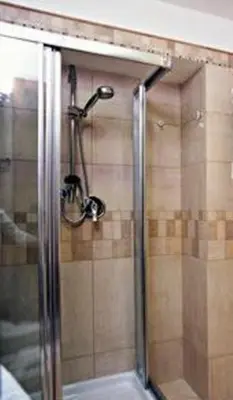 a shower with a glass door in a bathroom at Hotel Moscatello in Rome