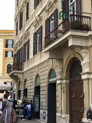 a building with people standing outside of it at 207 Inn in Rome