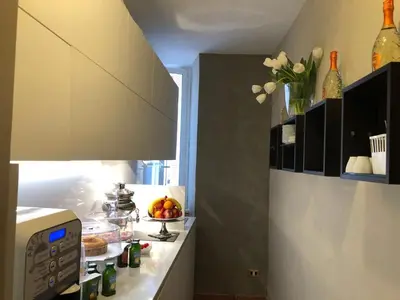 a kitchen with a microwave and a counter with food at 207 Inn in Rome