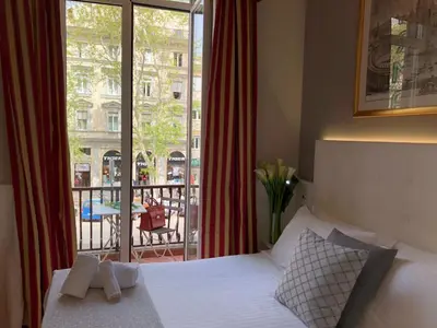 a bedroom with a bed and a view of a balcony at 207 Inn in Rome