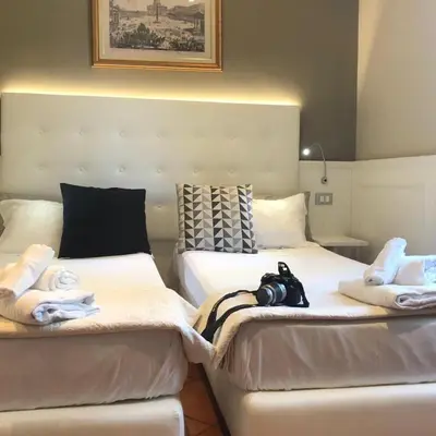 two beds sitting next to each other with towels on them at 207 Inn in Rome