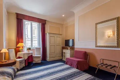a hotel room with a bed and a mirror at Relais Hotel Antico Palazzo Rospigliosi in Rome