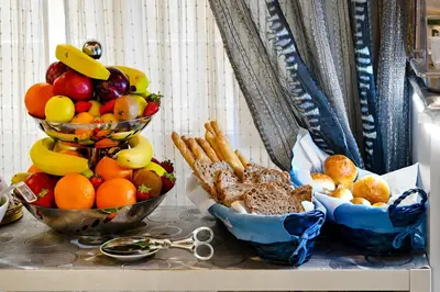 a table with two bowls of fruit and other foods at Notti A Roma in Rome