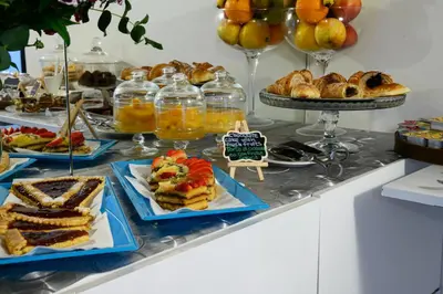 a buffet of food with sandwiches and other desserts at Notti A Roma in Rome