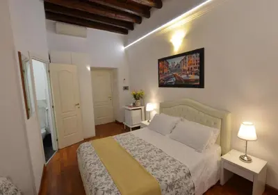 a bedroom with a bed and two tables with lamps at Notti A Roma in Rome