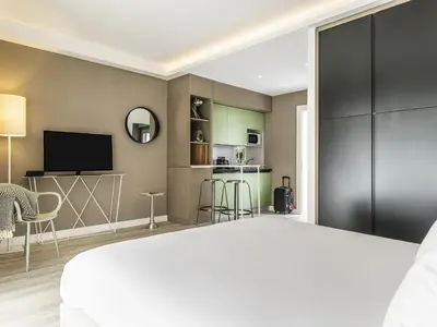 a radio sitting on top of a desk with a laptop at Aparthotel Adagio Rome Vatican in Rome