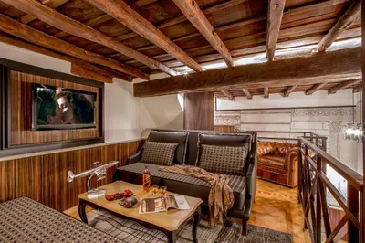 a living room with a couch and a table at The Inn at the Roman Forum Luxury Collection - The Inn At The Roman Forum in Rome