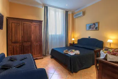 a living room with a couch and a table at Hotel Caracciolo in Rome