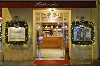 a store front of a restaurant with christmas lights at Hotel Homs in Rome