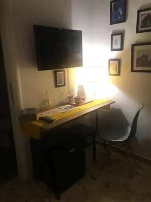 a desk with a computer monitor on top of it at Ai Senatori in Rome