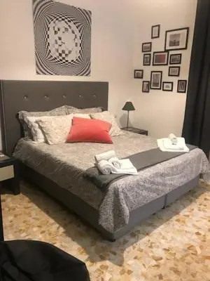 a bedroom with a bed with a red pillow at Ai Senatori in Rome