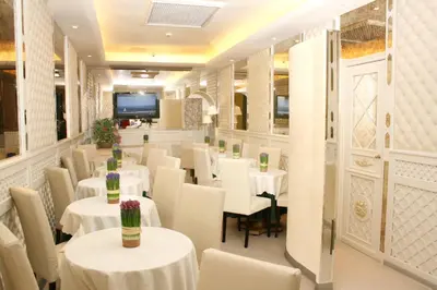 a restaurant with white tables and white chairs at Hotel Valle in Rome