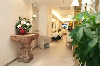 a room with a table with a vase of flowers at Hotel Valle in Rome