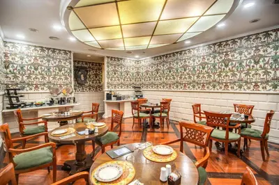 a restaurant with tables and chairs and a bar at The Britannia Hotel in Rome