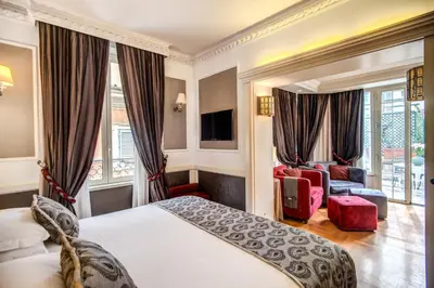 a hotel room with a bed and a chair at The Britannia Hotel in Rome