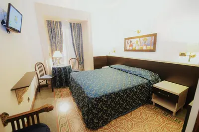 a hotel room with a bed and a table at Hotel Sweet Home in Rome