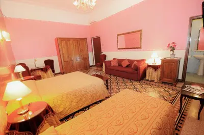 a hotel room with two beds and a couch at Hotel Sweet Home in Rome