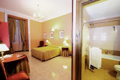 a hotel room with a bed and a bathroom at Hotel Sweet Home in Rome