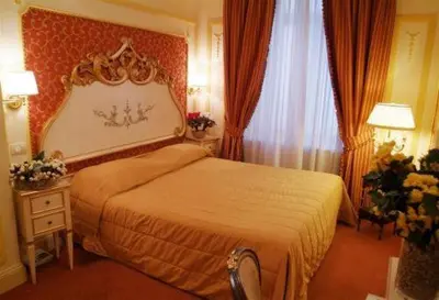 a hotel room with a bed and a window at Hotel Champagne Palace in Rome