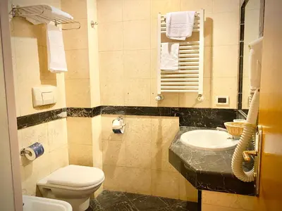 a bathroom with a toilet and a sink at Hotel Champagne Palace in Rome