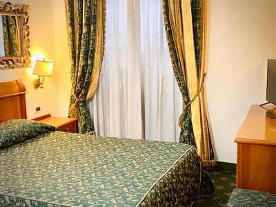a hotel room with a bed and a window at Hotel Champagne Palace in Rome