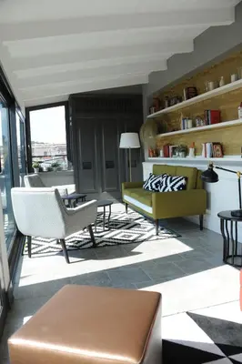 a living room with a couch and a chair at Trianon Borgo Pio Aparthotel in Rome