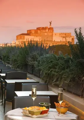 a restaurant with tables with a view of the eiffel tower at Trianon Borgo Pio Aparthotel in Rome