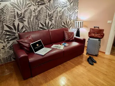 a brown leather couch with a laptop on it at Trianon Borgo Pio Aparthotel in Rome