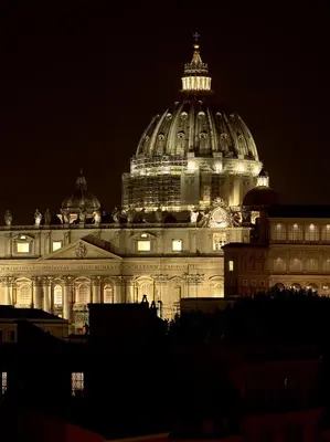 a large building is lit up at night at Trianon Borgo Pio Aparthotel in Rome
