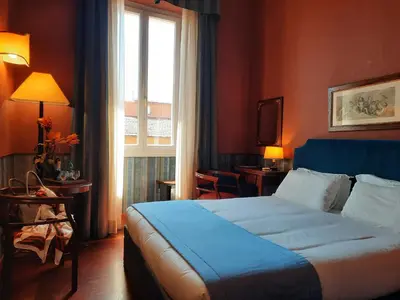 a hotel room with a bed and a window at Domus Livia in Rome