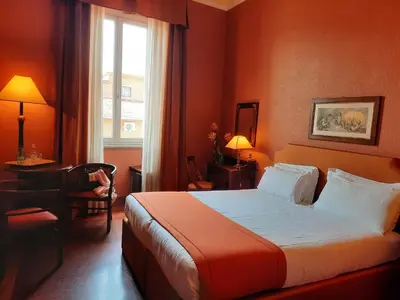 a hotel room with a bed and a window at Domus Livia in Rome