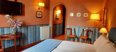 a bedroom with a bed and two chairs and a television at Domus Livia in Rome