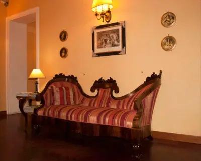 a couch sitting in a living room with a lamp at Domus Livia in Rome