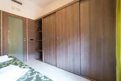 a bedroom with wooden cabinets and a bed at Residence Europa in Rome
