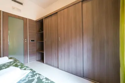 a bedroom with wooden cabinets and a bed at Residence Europa in Rome