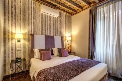 a bedroom with a large bed in a room at Trevi Beau Boutique Hotel in Rome