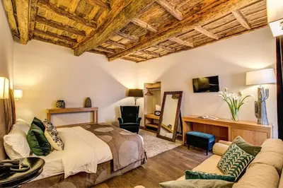a bedroom with a bed and a couch at Trevi Beau Boutique Hotel in Rome