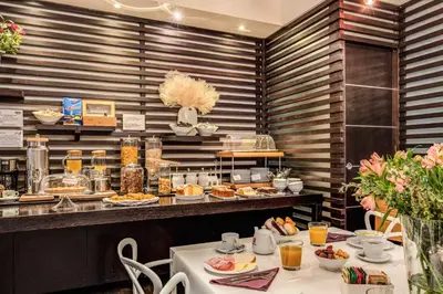 a restaurant with a buffet with plates of food at Trevi Beau Boutique Hotel in Rome
