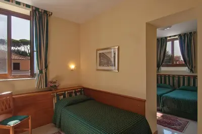 a bedroom with two green beds and a window at Residenza Paolo VI in Rome